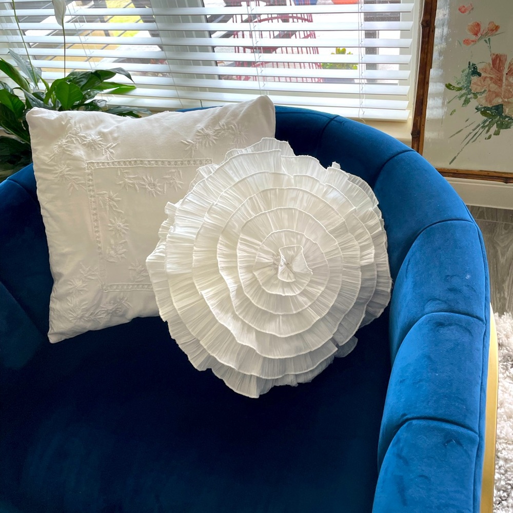 Two white throw pillows.  One round and one square.